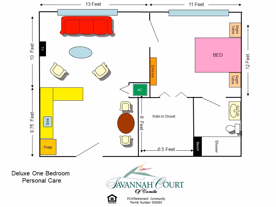 Floor plan of a deluxe one-bedroom personal care unit at Savannah Court of Camilla, showing a living room with a red couch, two chairs, and a TV, a kitchen area with a fridge and sink, a dining area with a round table and three chairs, a bedroom with a bed and two night tables, a walk-in closet, and a bathroom with a shower, sink, and toilet.