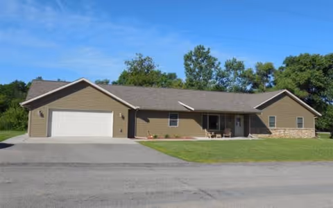 Front view of River Way North Adult Family Home, a single-story house with a two-car garage.