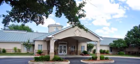 Front view of Brookdale Oakwell facility with covered entrance and well-kept landscaping.
