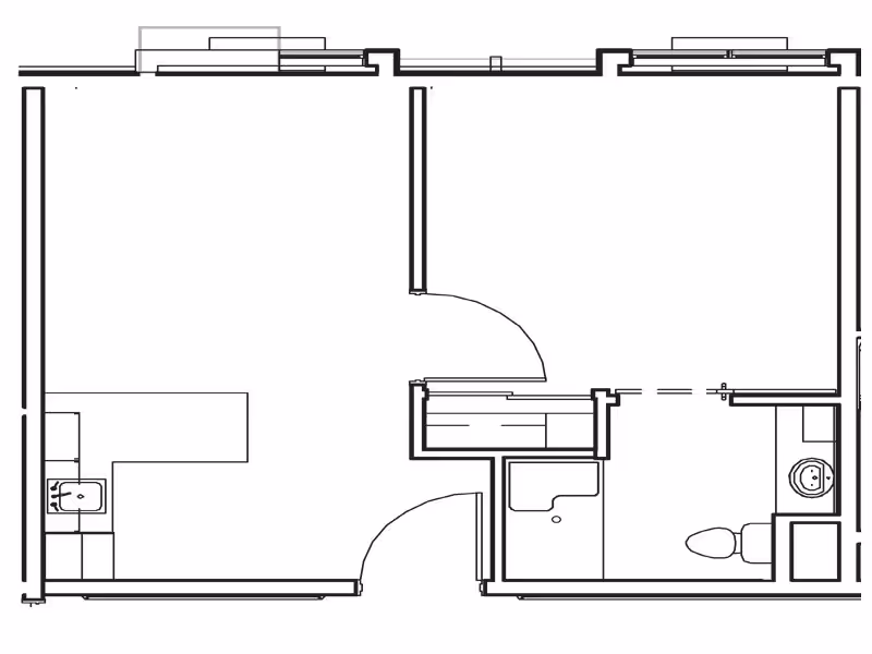 Black-and-white floor plan of a small apartment unit showing two main rooms, a kitchenette with a sink, and a bathroom with a toilet and sink.