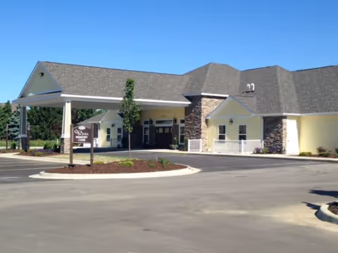 Vicinia Gardens front entrance with covered drop-off and stone accents.