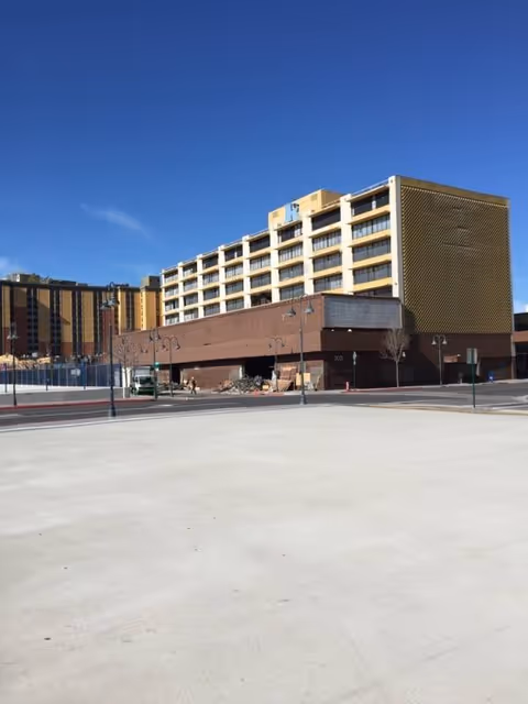 Exterior view of a large senior living facility with a wide front entrance.