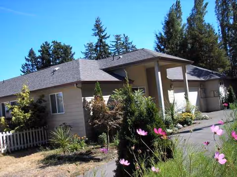 Single-story senior living facility with a landscaped front yard and covered entrance.