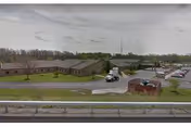 Exterior view of RRH Edna Tina Wilson Living Center campus with low buildings and parking.