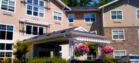 Exterior view of Brookdale Oswego Springs Portland senior living building with a covered entrance.