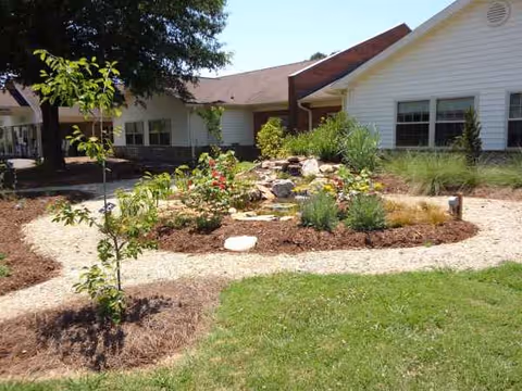 Front exterior of Cross Road Retirement Community with landscaped garden beds