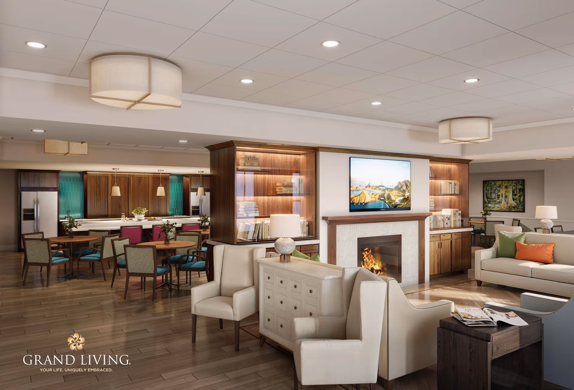 A spacious and modern senior living common area featuring a cozy seating arrangement with armchairs and sofas around a fireplace with a mounted TV above it. The room has wooden flooring, built-in bookshelves with books and decorative items, and a dining area with tables and chairs in the background near a kitchen with wooden cabinetry and stainless steel appliances. The space is well-lit with ceiling lights and pendant lamps.