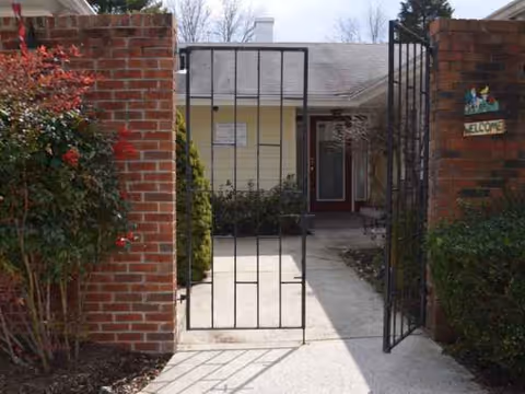 Gated brick entrance to Angels Garden II senior living, walkway to the building front.