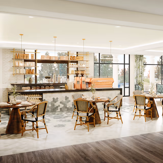 Bright and modern dining area with round wooden tables and wicker chairs arranged neatly. The space features a coffee bar with shelves holding jars, cups, and coffee equipment. Large windows allow natural light to fill the room, and there are plants on the tables and near the windows.