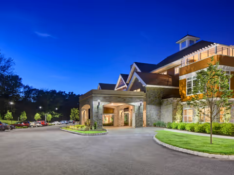 Exterior view of Maplewood at Stony Hill front entrance with stone facade and landscaping.
