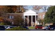 Williamsville Suburban Safire Nursing and Rehabilitation Center brick building with white portico and parked cars.