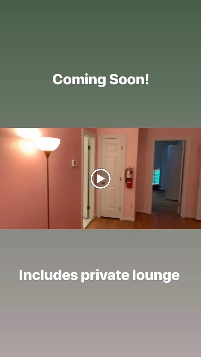 Interior view of a pink-walled private lounge with a floor lamp, several doors, and hardwood flooring, overlaid with the text 'Coming Soon!' and 'Includes private lounge'.