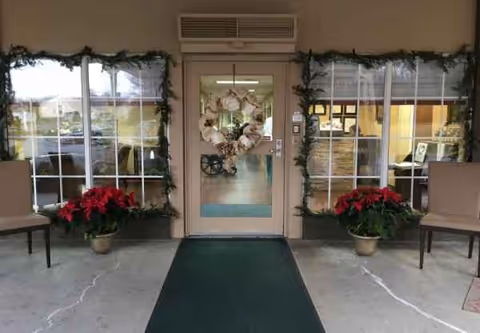 Exterior entrance of Grace Health and Rehab Center with wreaths and poinsettias.