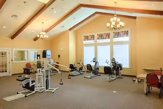 Indoor fitness area at The Crescent with cardio machines and weight training equipment.