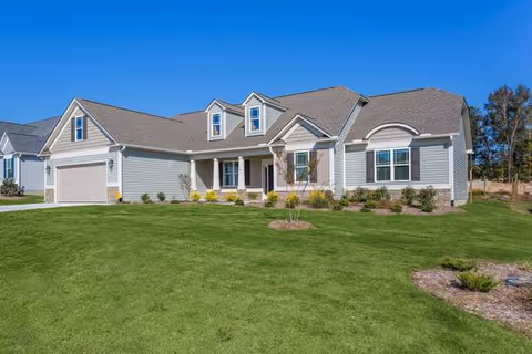 Exterior of Miss Bell’s Assisted Living of Garner with a manicured front lawn.