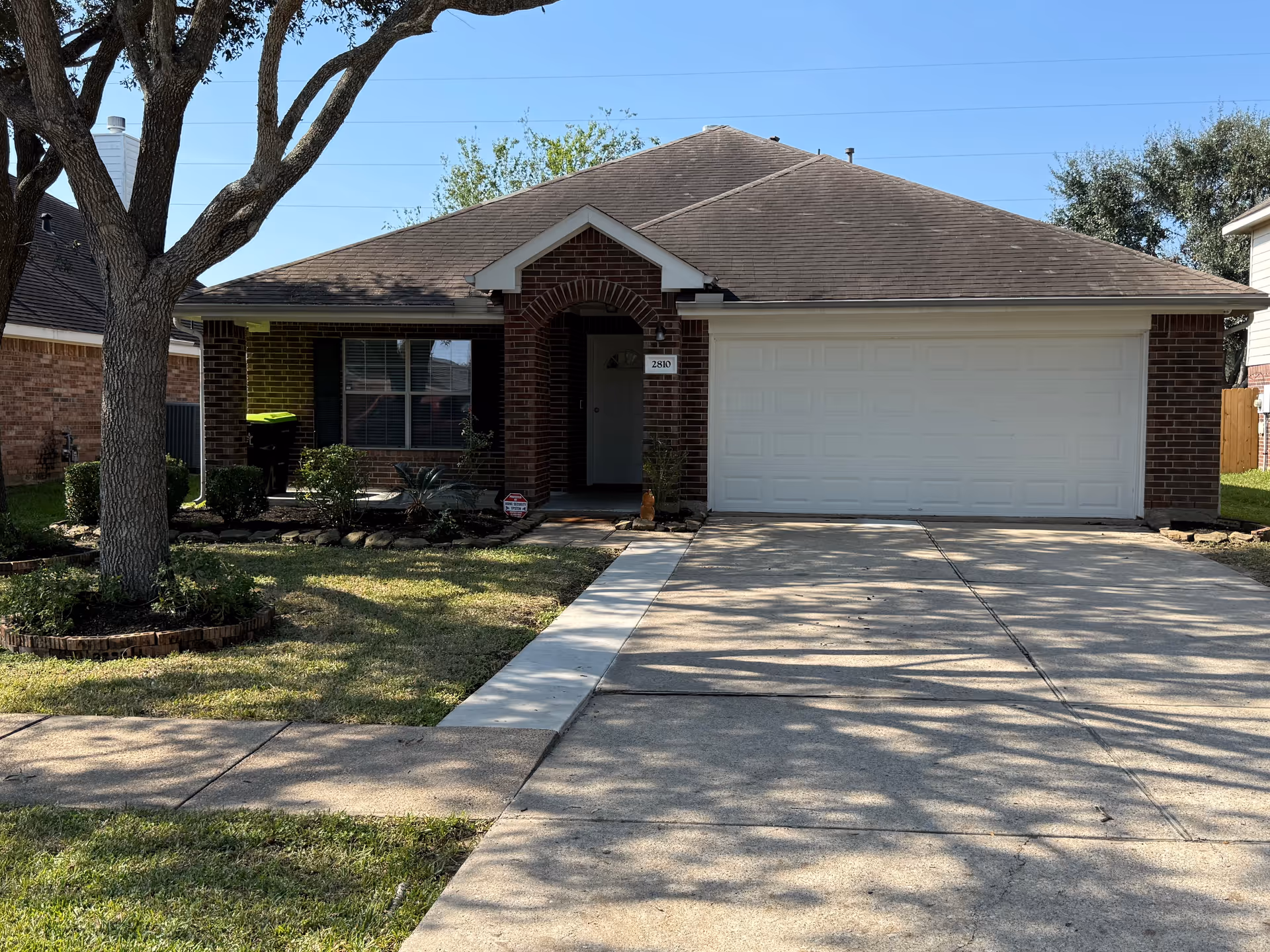 Exterior view of Shepherd Personal Care Home showcasing the front yard and garage.