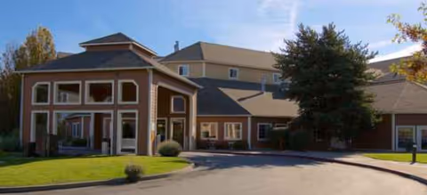 Exterior view of Brookdale Richland senior living facility with curved driveway and glass entrance.