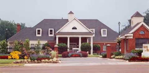Front view of Bellevue Woods BW Management senior living facility with landscaped entrance.
