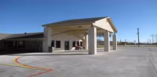 Exterior view of Lone Star Ranch Rehabilitation and Healthcare Center entrance with porte-cochere.