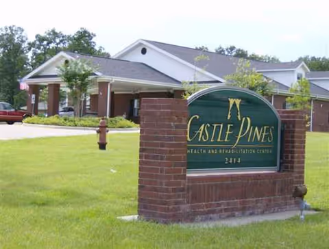 Front view of Castle Pines Health and Rehabilitation facility sign in green with brick support