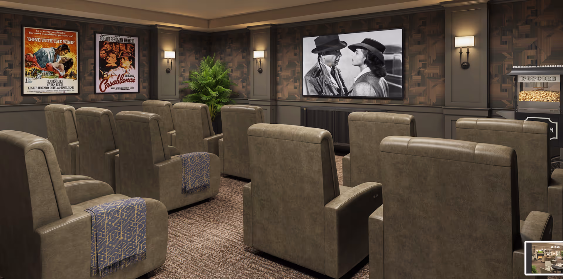 A cozy senior living facility movie theater room with rows of comfortable brown leather recliner chairs, each with a patterned throw blanket. The room features a large screen showing a black and white movie scene, vintage movie posters on the wall, warm wall sconces for lighting, a popcorn machine, and a potted plant in the corner.