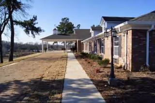 Exterior view of NorthCliff Assisted Living, a brick facility with a covered entrance and walkway.