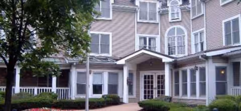 Brookdale Kenwood exterior with entrance and manicured landscaping in front