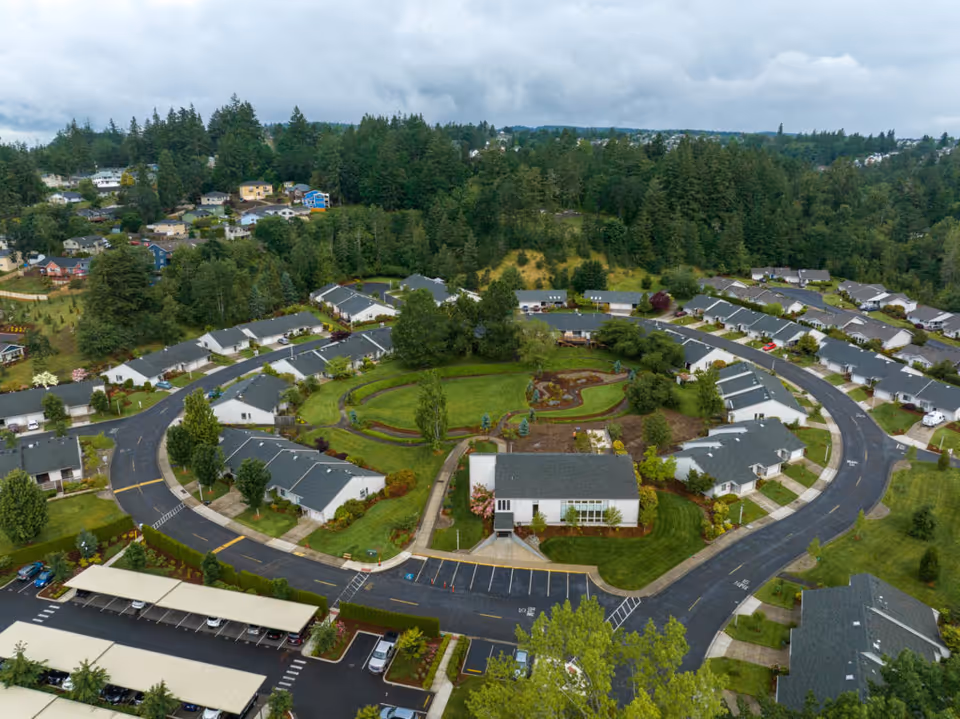 Aerial view of Broadway Cityview's circular campus of single-story homes surrounding a landscaped central green.