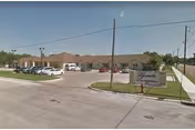Front exterior view of Ganado Nursing and Rehab Center with parking lot and sign