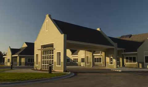 Exterior front view of Borgess Gardens senior living facility with a covered entrance.