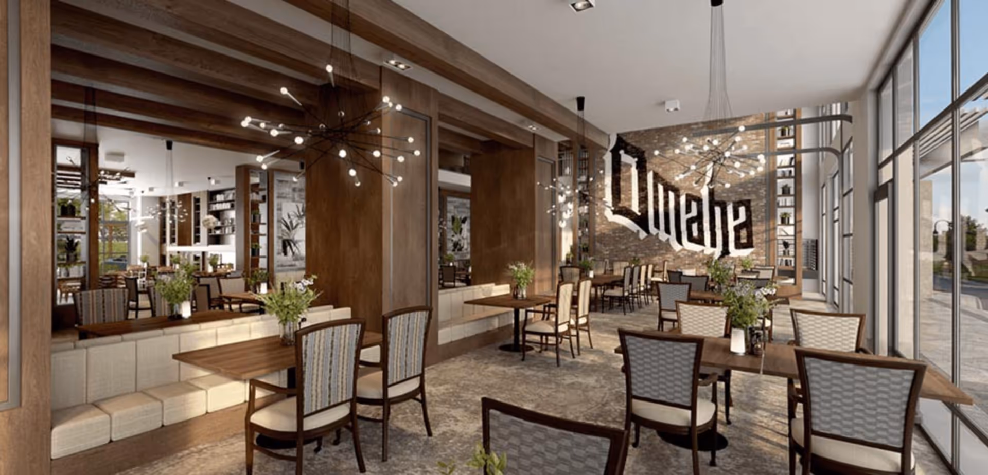 Bright, modern dining room with wooden tables and upholstered chairs, decorative pendant lighting, large windows, and a wall mural that reads 'Ovation'.