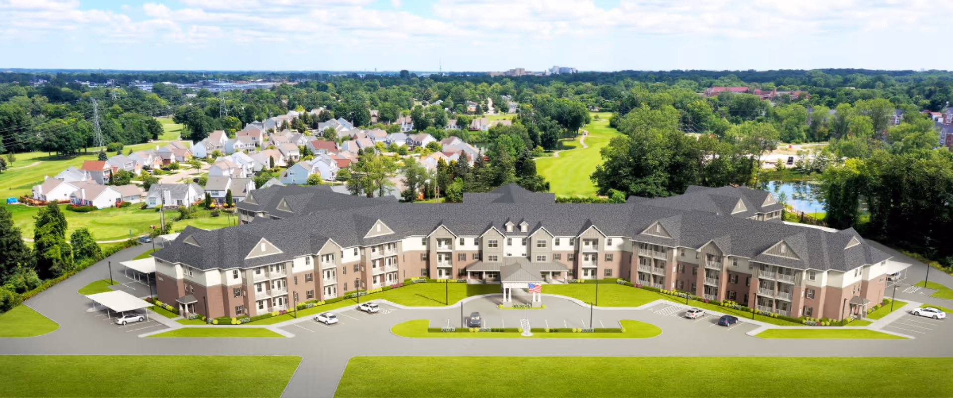 Aerial view of the American House Village at Bloomfield senior living facility surrounded by greenery and residential homes.