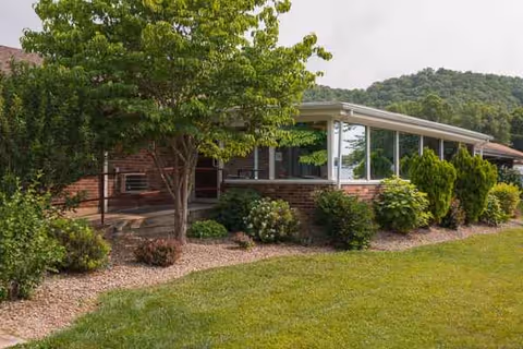 Exterior view of Life Care Center of Morehead with a covered entry and landscaped front.