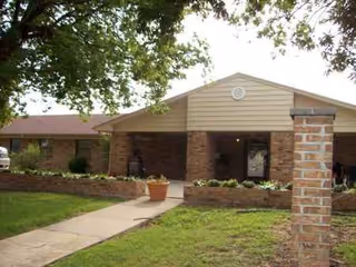 Elmwood Manor Nursing Home exterior with brick entry and walkway