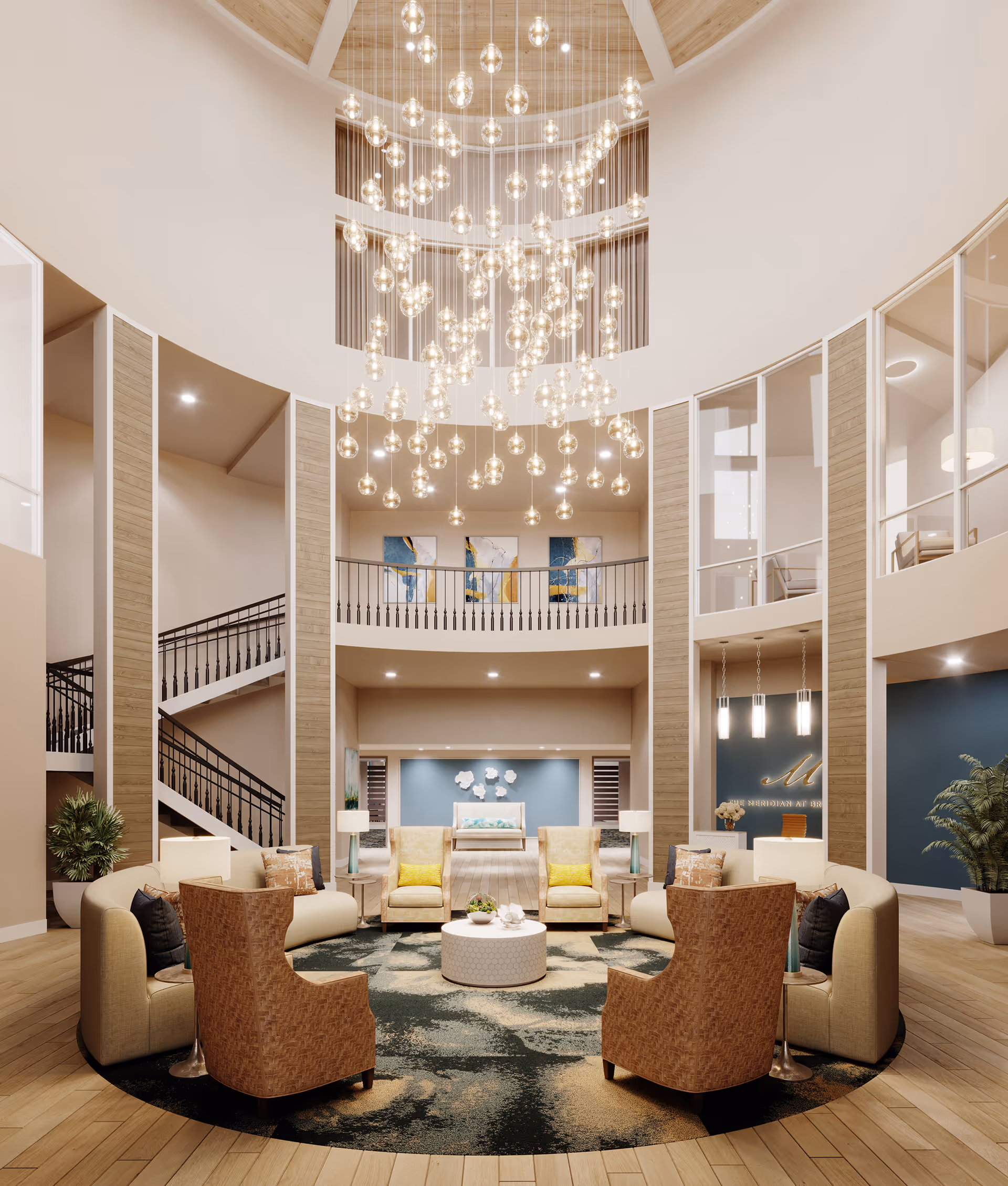 Spacious two-story senior living lobby with a circular seating arrangement beneath a large cascading chandelier.