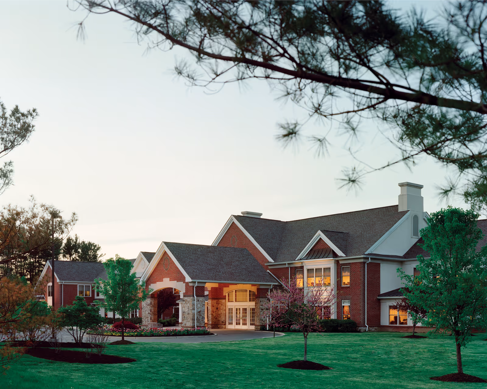 Exterior view of Brandywine Moorestown Estates by Monarch, brick building with entrance and landscaped lawn.