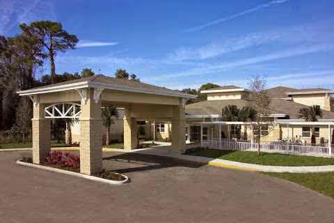 Exterior view of Pines of Sarasota Health Care entrance with porte-cochere.