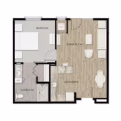 Floor plan of a senior living unit at StoneCreek of Flying Horse Senior Living showing a bedroom, bathroom, kitchenette, and living room area.