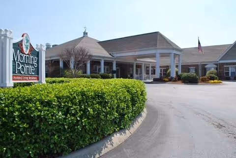 Exterior view of Morning Pointe of Athens with sign, entrance, and trimmed hedges