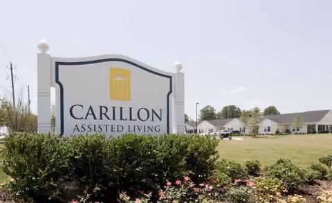 Exterior sign reading Carillon Assisted Living at TerraBella Durham with landscaping