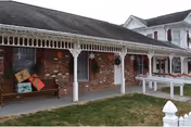 Exterior view of Skyview Springs Rehab And Nursing Center with brick facade, white porch, and columns.