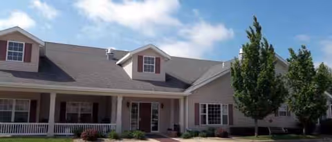 Front exterior of Shelbyville Manor, a single-story senior living facility with a covered entrance.