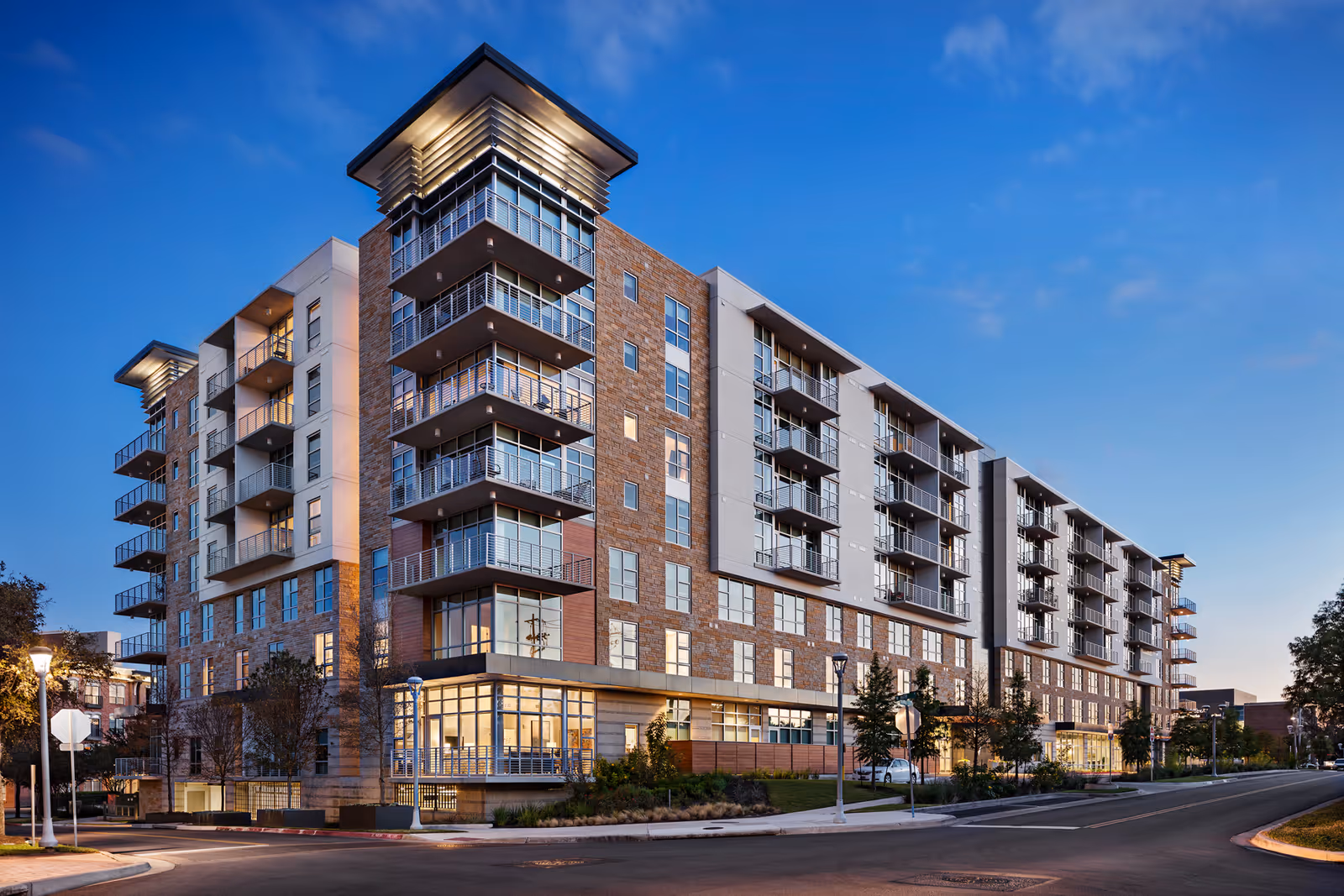 Modern senior living building with balconies along a street