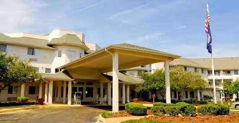 The Fairmont by Barclay House senior living facility entrance with a covered drop-off area.
