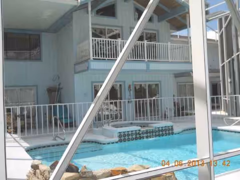 Light-blue senior living facility exterior with a pool and balconies.