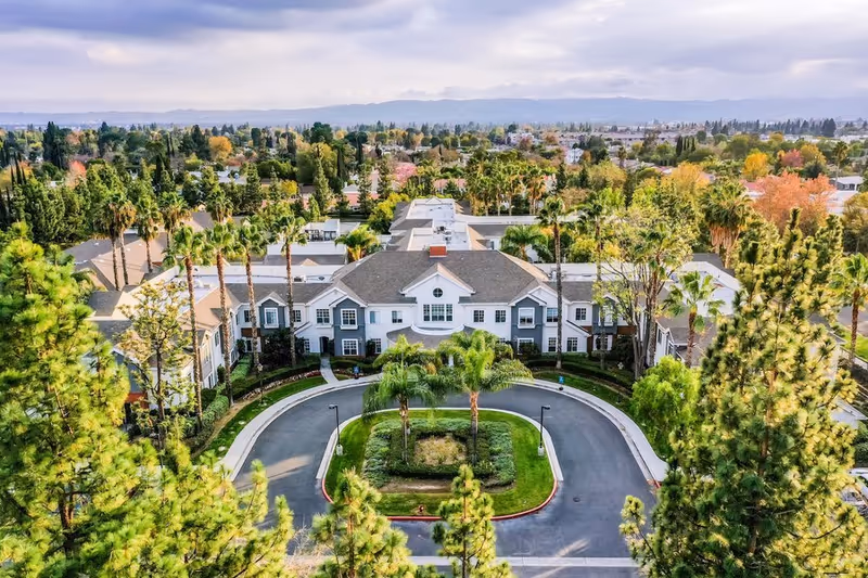 Aerial view of Gardens at Northridge campus with a circular driveway and lush landscaping.