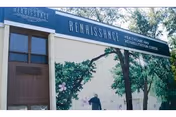 Exterior view of Renaissance Healthcare and Rehabilitation Center building with a mural of trees and a person on the wall beneath the facility's name sign.