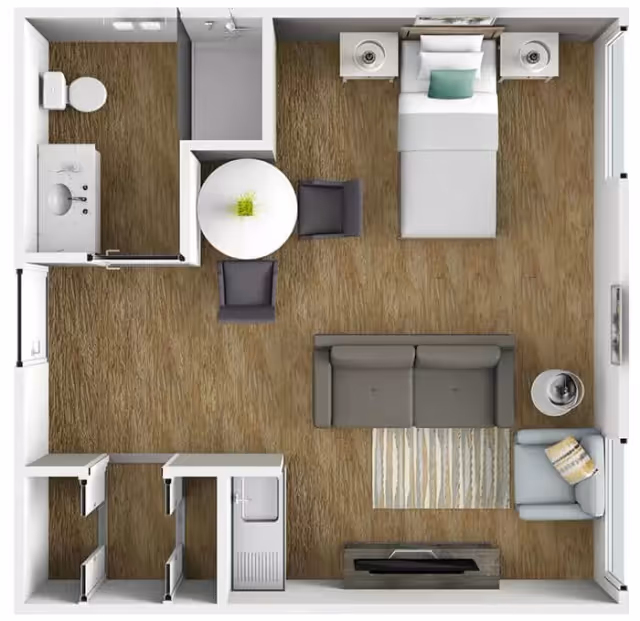 Top-down view of a studio apartment floor plan featuring a bedroom area with a bed and two nightstands, a living area with a sofa, armchair, side table, and TV, a small dining area with a round table and two chairs, a bathroom with a toilet, sink, and shower, and a kitchenette with a sink and storage cabinets.