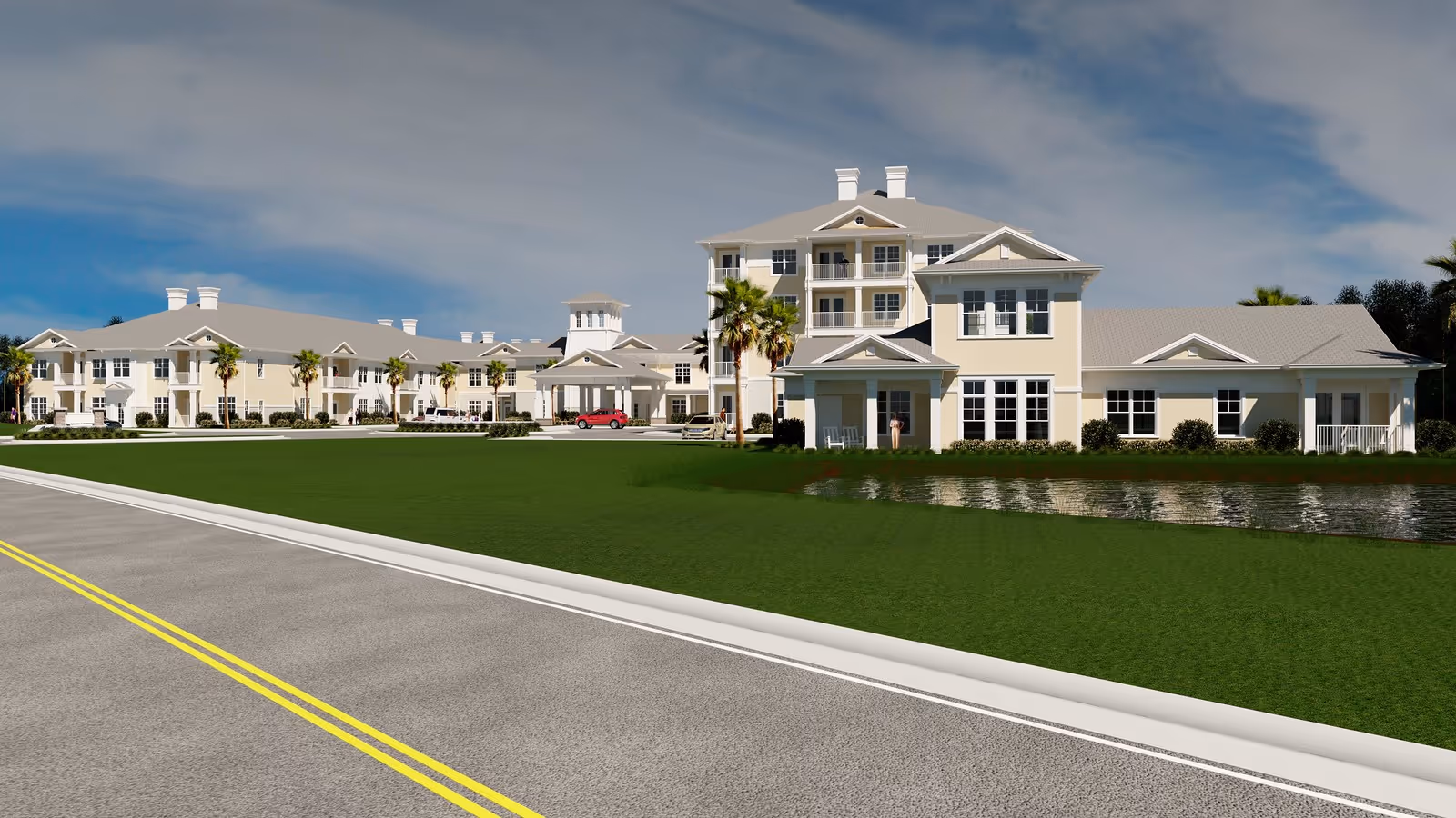 Exterior view of a large, multi-story senior living facility with beige walls and gray roofs, surrounded by green lawns, palm trees, and a small pond. A paved road with yellow lines runs in the foreground under a partly cloudy sky.
