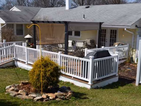 Outdoor deck area of Angels Garden II with grill and seating.